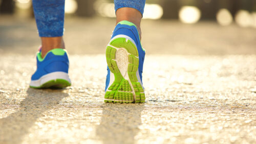 An adult running shoe poised for physical activity to boost their wellbeing.
