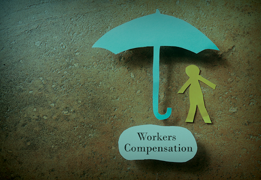 A paper cut out of an umbrella and person with 'workers compensation' as a puddle under the umbrella.