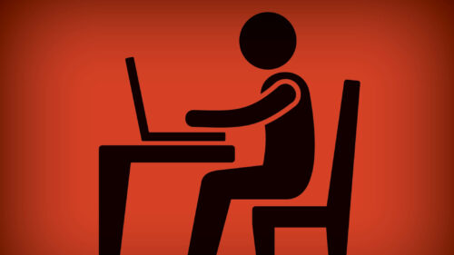 A graphic of an employee sitting at their desk