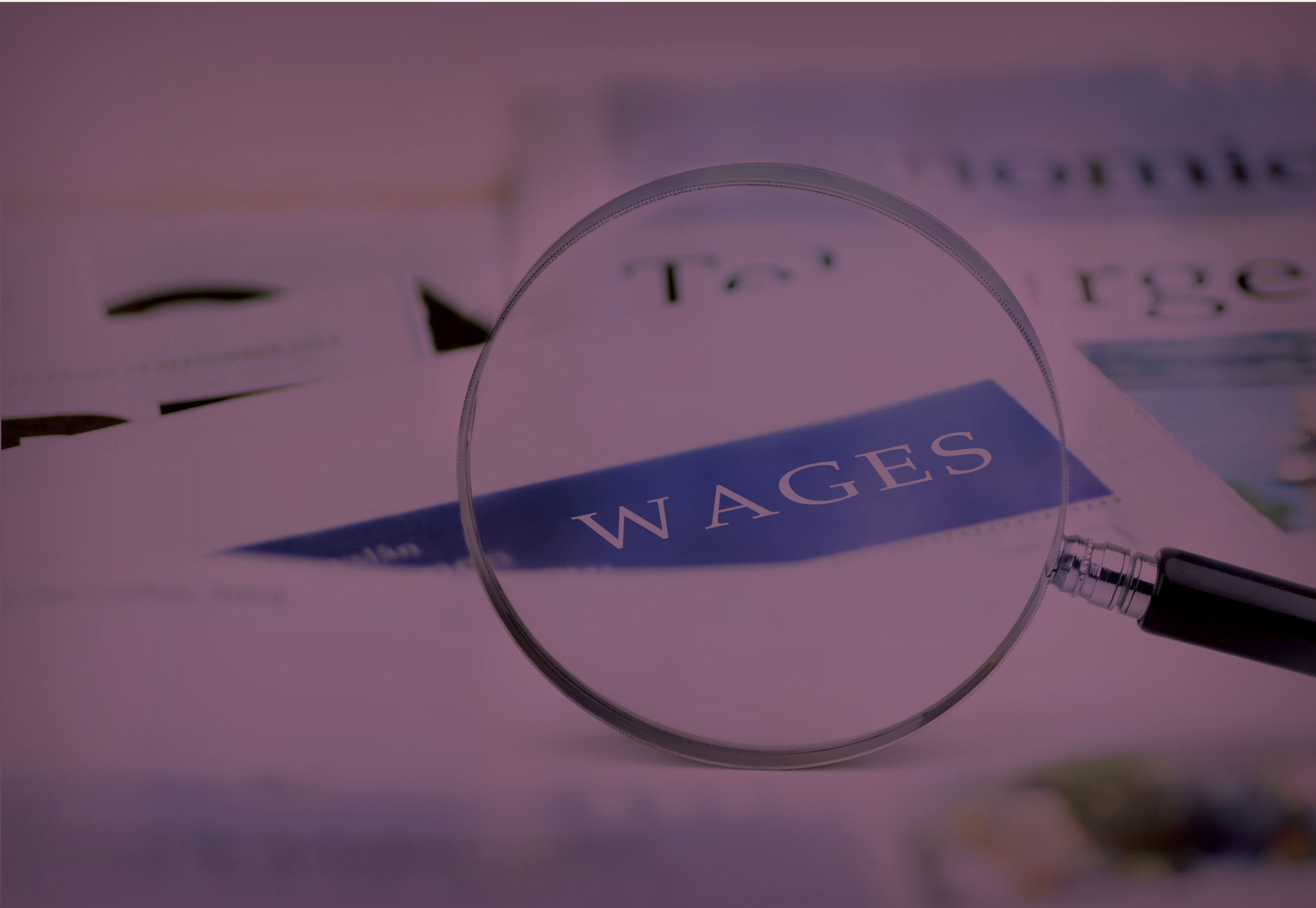 A magnifying glass that highlights the word wages.