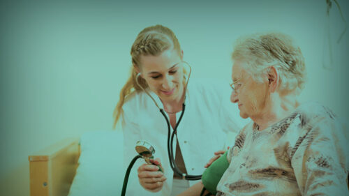 A healthcare provider caring for an older person