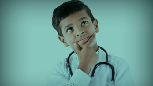 child wearing stethoscope with a questioning look on his face