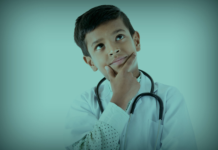 child wearing stethoscope with a questioning look on his face