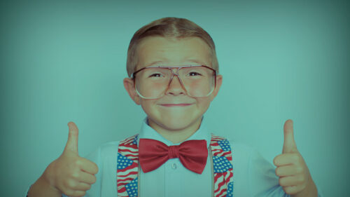 boy dressed in red, white, and blue suspenders and bow tie