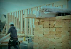 A man constructing a commercial building with timber.