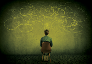 A man staring at a chalk board wondering