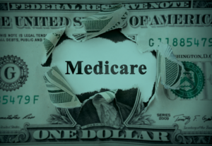 US money with the word medicare carved out