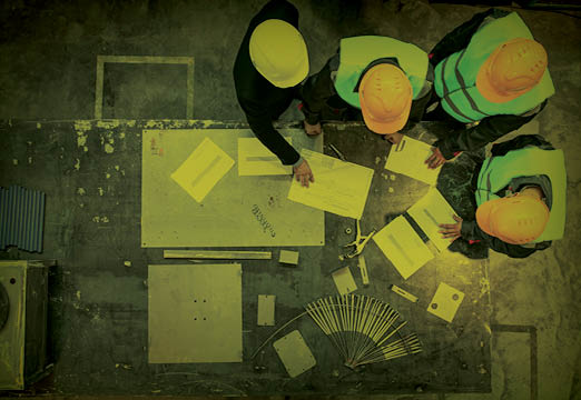 men discussing surety bonds at a construction site.