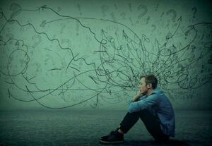 man struggling with health insurance and mental wellbing