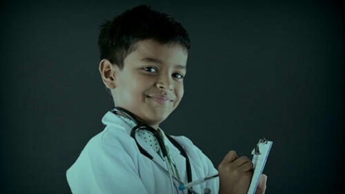a boy pretending to be a doctor in healthcare