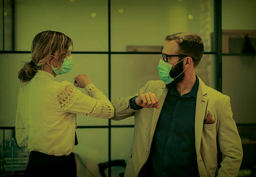 coworkers managing risk with elbow bumps