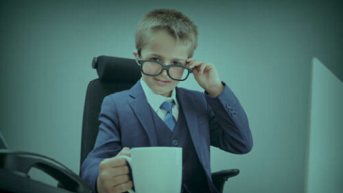 a boy sitting at a work desk