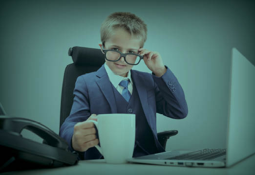 a boy sitting at a work desk