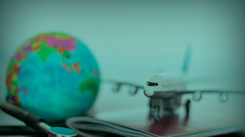 A globe sitting next to an airplane