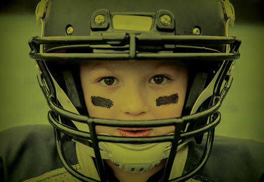 A child wearing a football helmet