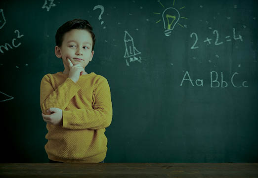 A child thinking with math around them on a blackboard.