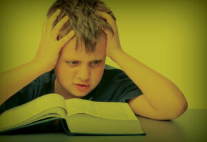 A confused boy reading about healthcare