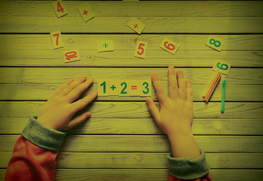A child using number pieces