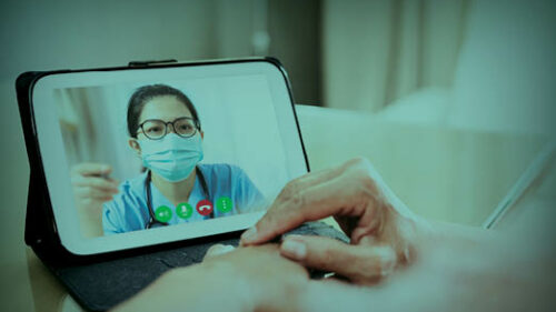 A doctor on a tablet talking to a paitent