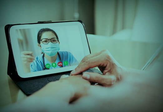 A doctor on a tablet talking to a paitent