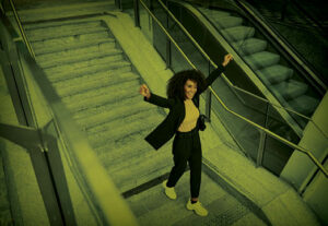 An employee dancing up stairs