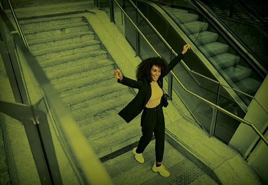 An employee dancing up stairs