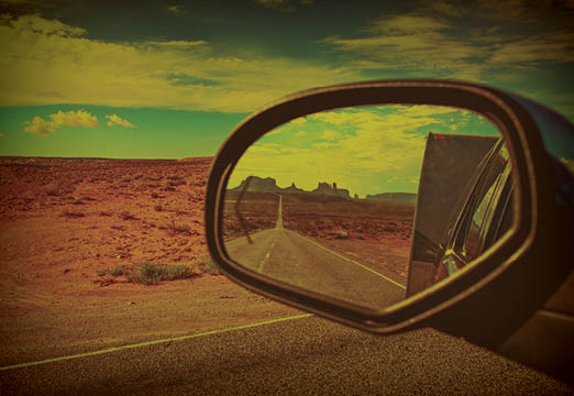 A car side mirror with a landscape