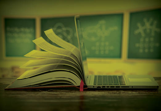 A book and computer in a classroom