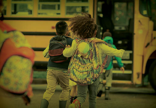 A girl running to the school bus