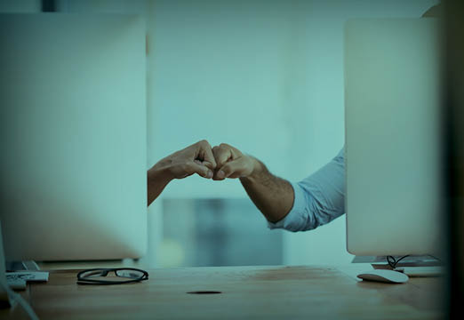 Two coworkers greeting each other