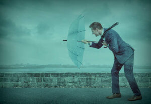 A man walking against a rain storm