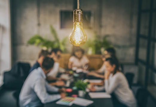 A lightbulb over a meeting table