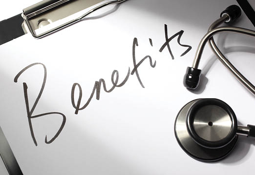 The word benefits scrawled across a clipboard next to medical equipment
