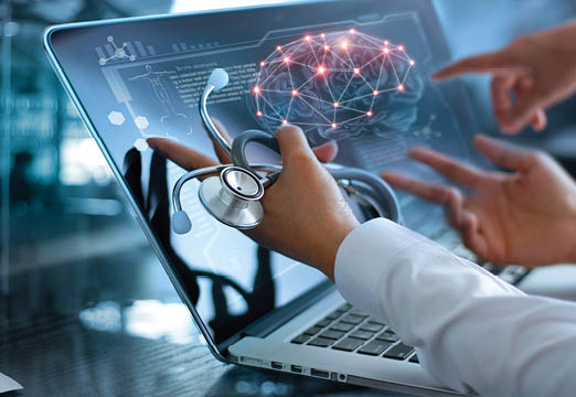 A doctor examining a brain on a laptop