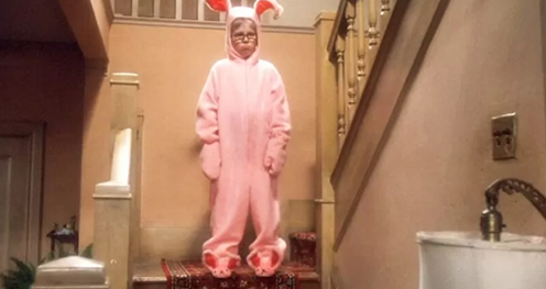 A tween boy sad about wearing a pink bunny suit