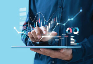 A person using a tablet with graphs