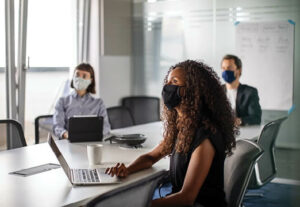 Office workers wearing face masks during a meeting