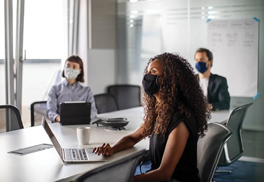 Office workers wearing face masks during a meeting