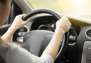A person holding a steering wheel