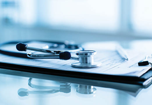 a stethoscope and healthcare papers