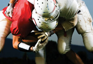 two football players tackling