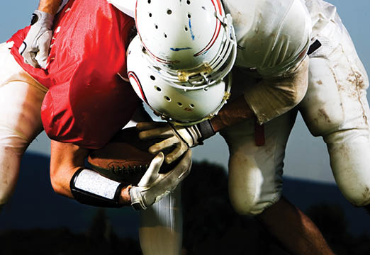 two football players tackling