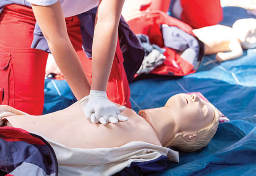 A person practicing cpr on a dummy