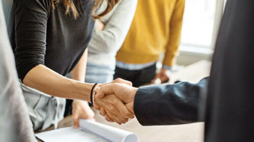 Business Professionals shaking hands at a meeting