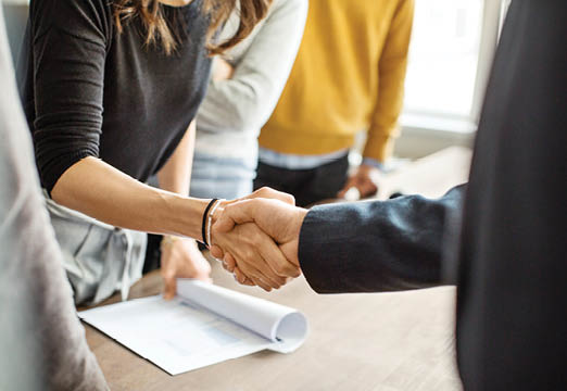 Business Professionals shaking hands at a meeting
