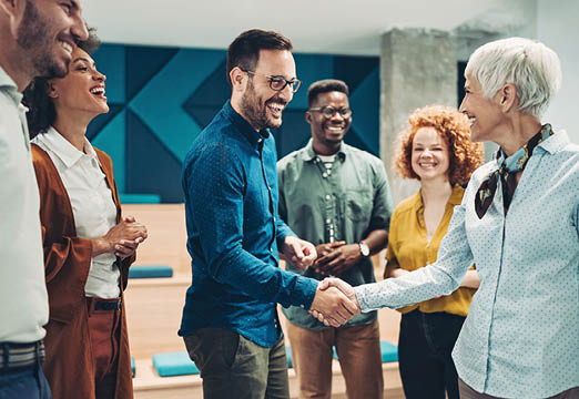 A diverse group of employees smiling and laughing