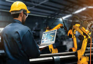 A male employee using technology for manufacturing