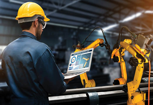 A male employee using technology for manufacturing