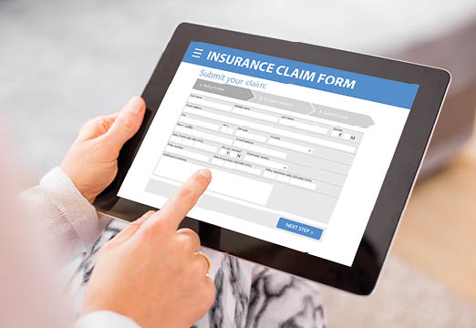 An online insurance claims form displayed on a tablet