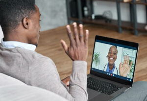 A man talking to a doctor on a computer screen